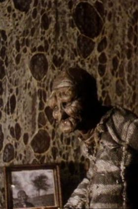 The Man in the Lower-Left Hand Corner of the Photograph